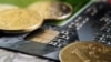 Coins lie on the credit card close up. Coins of bank of Russia. Small depth of sharpness. Blackout at the edges. Indoors. Horizontal format. Color. Photo.